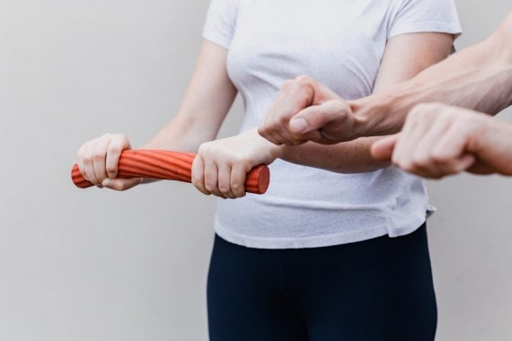 a woman holding a red handle while standing next to a man